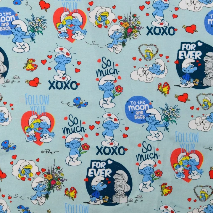 Köp nu Trikåtyg Smurfarna - Ljusblå botten